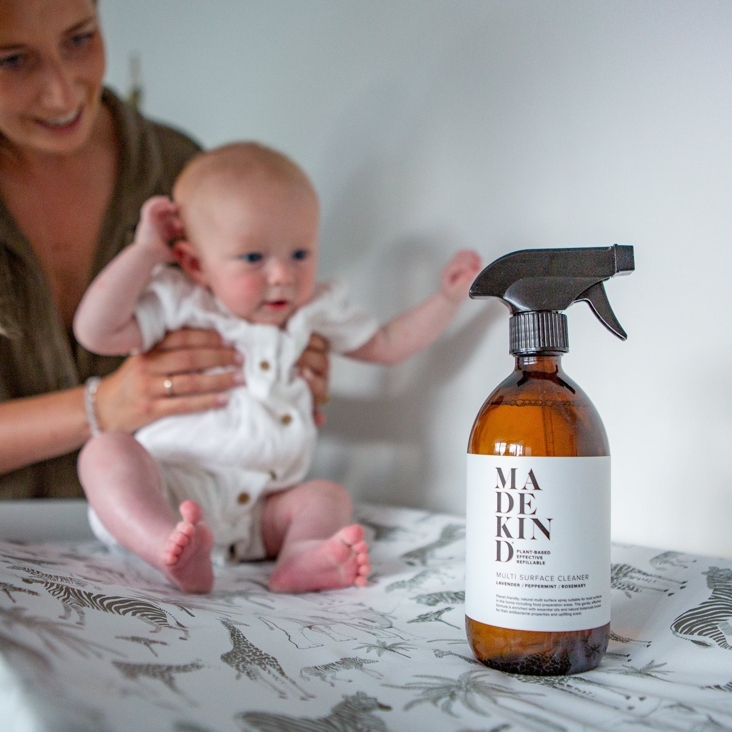 Mother holding baby on changing table