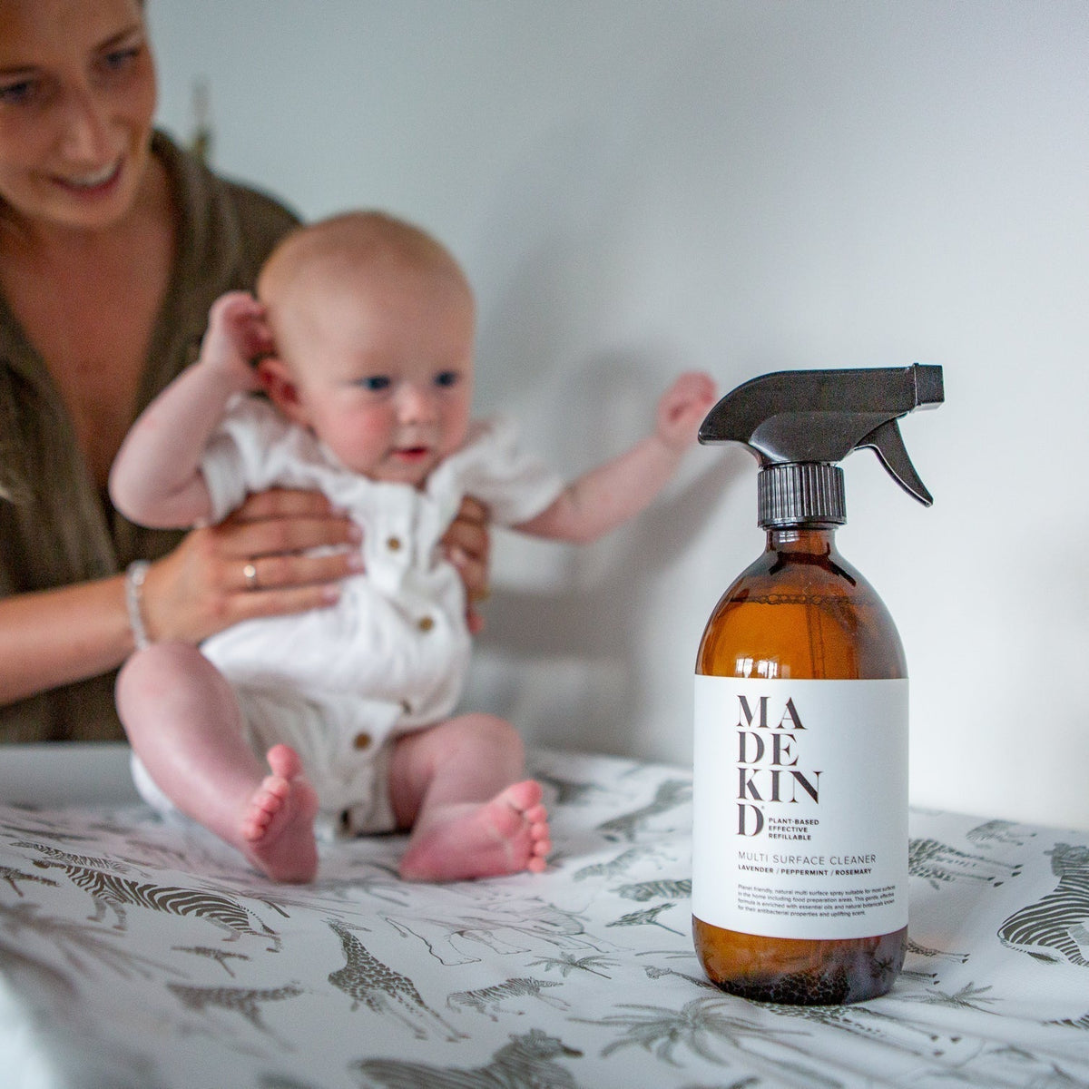 Mother holding baby on changing table