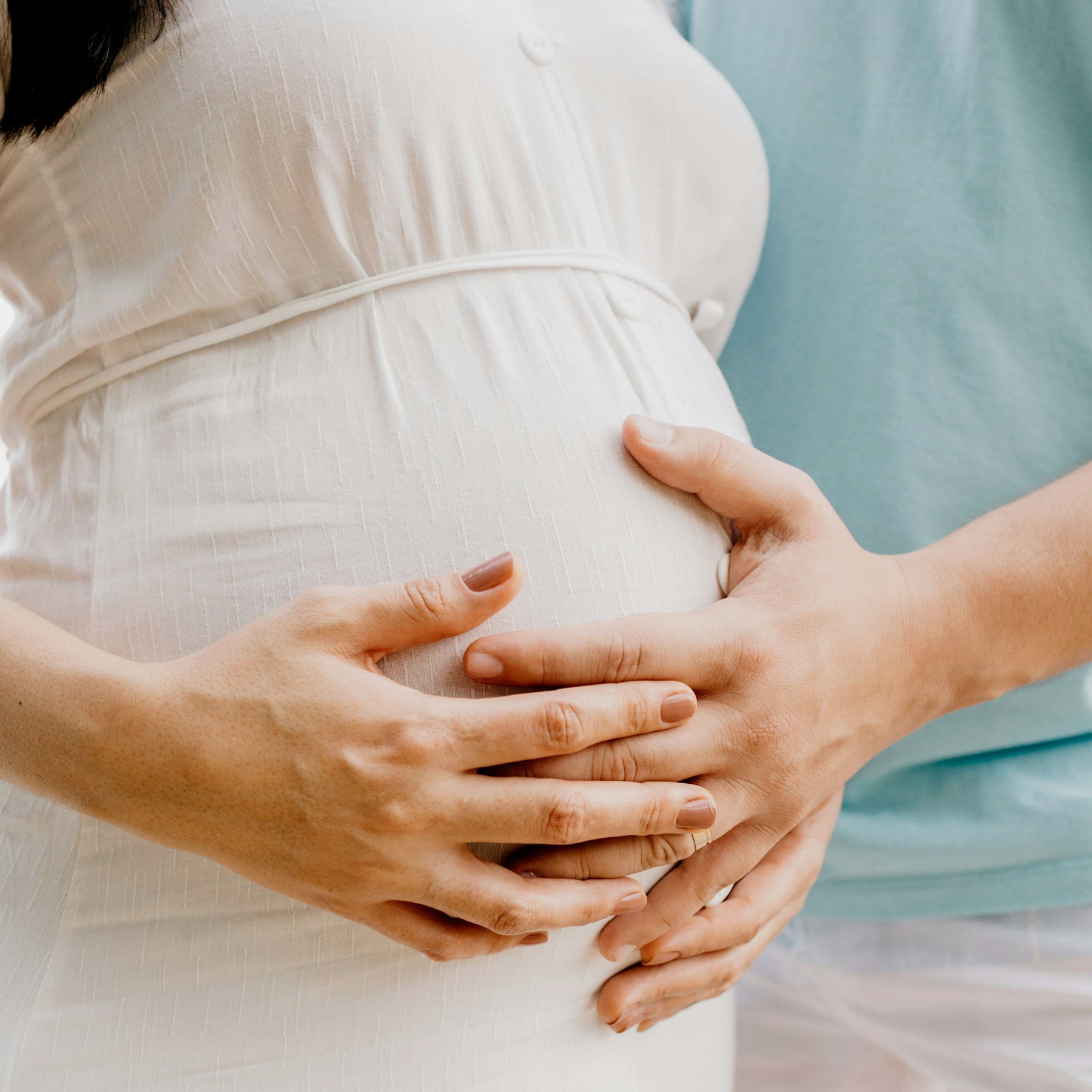 Pregnant woman with hands on stomach