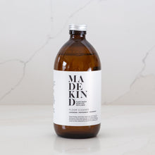 Load image into Gallery viewer, Photo of MadeKind Floor Cleaner in an amber glass bottle
