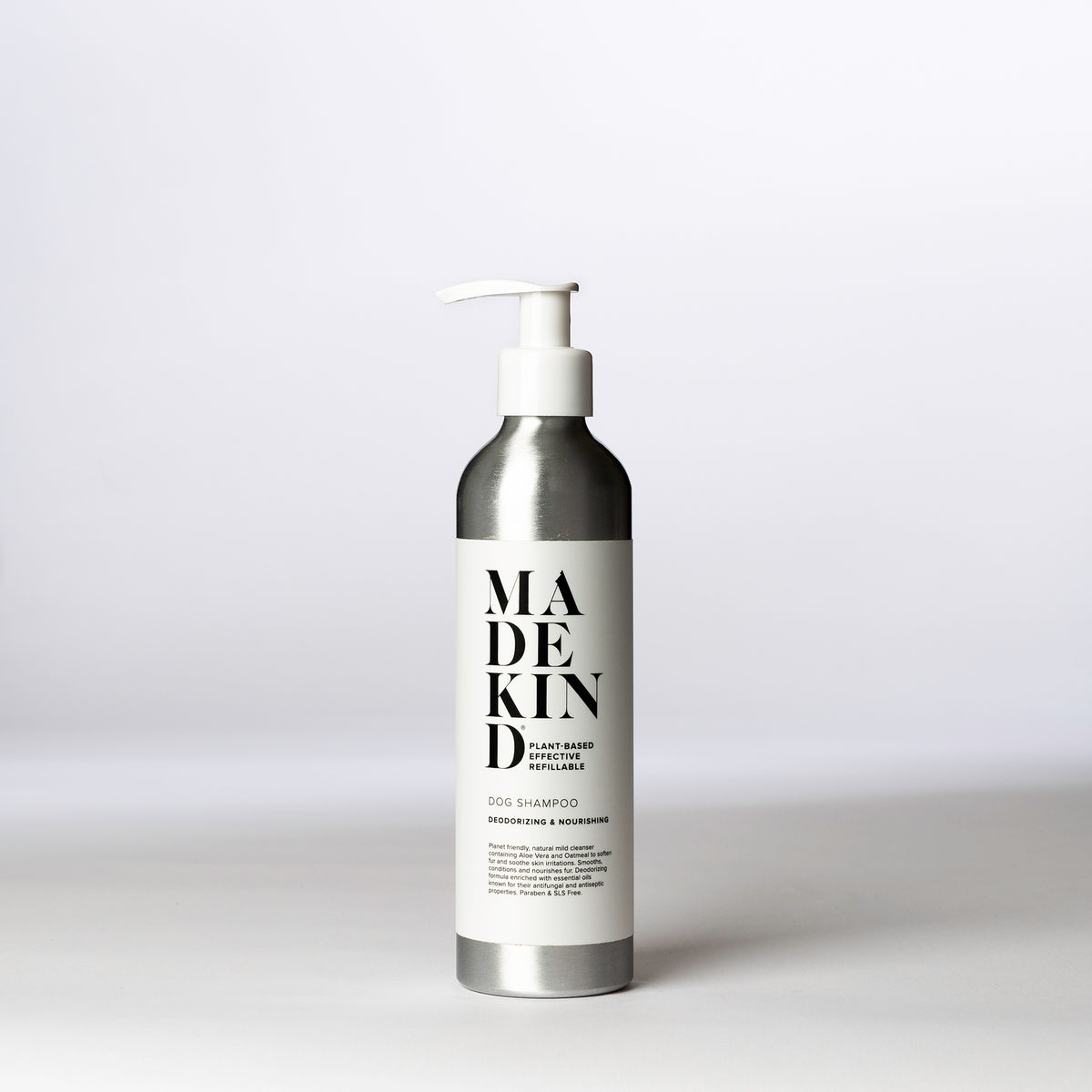 An aluminium bottle of MadeKind Dog Shampoo on a white surface