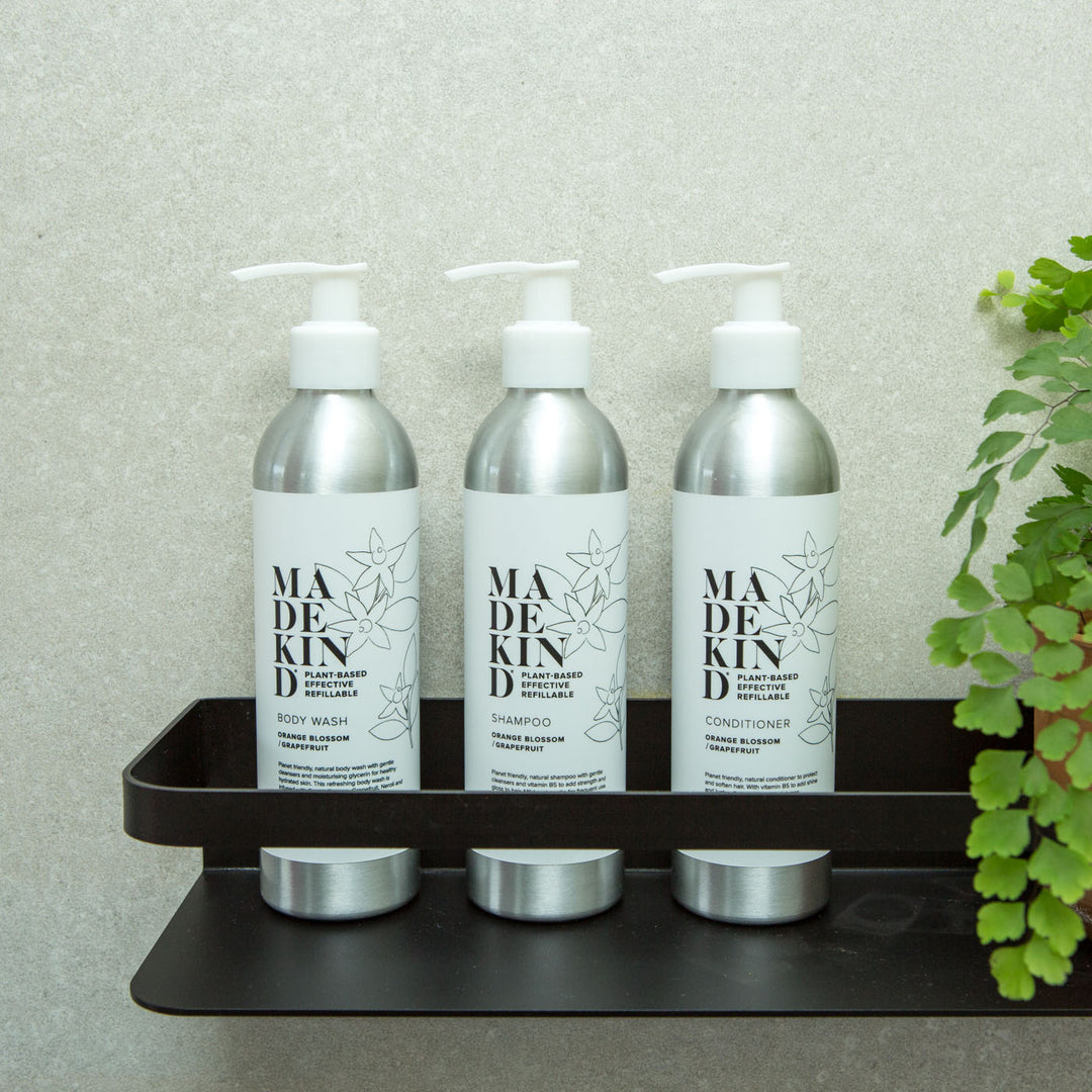 Photo of MadeKind's natural body wash, shampoo and conditioner on a shelf in a bathroom