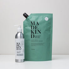 Load image into Gallery viewer, Photo of MadeKind body wash 1 Litre refill with an empty bottle
