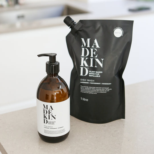 Madekind eco-friendly, sustainable dish wash refillable bottle and refill pouch on kitchen counter