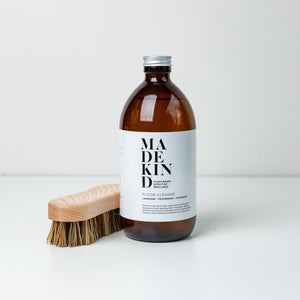 Photo of MadeKind 500ml non toxic floor cleaner with a wooden scrubbing brush