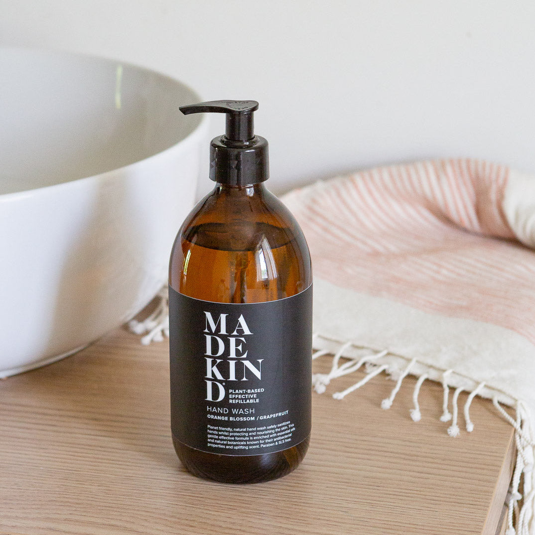 MadeKind natural hand wash 500ml in amber glass bottle in a modern bathroom by a sink