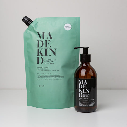 Photo of a 1 litre hand wash orange blossom & grapefruit with a MadeKind amber glass hand wash bottle