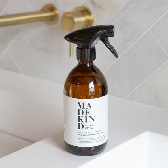 Photo of a Bottle of MadeKind bathroom cleaner on a bathroom sink with tiled wall background