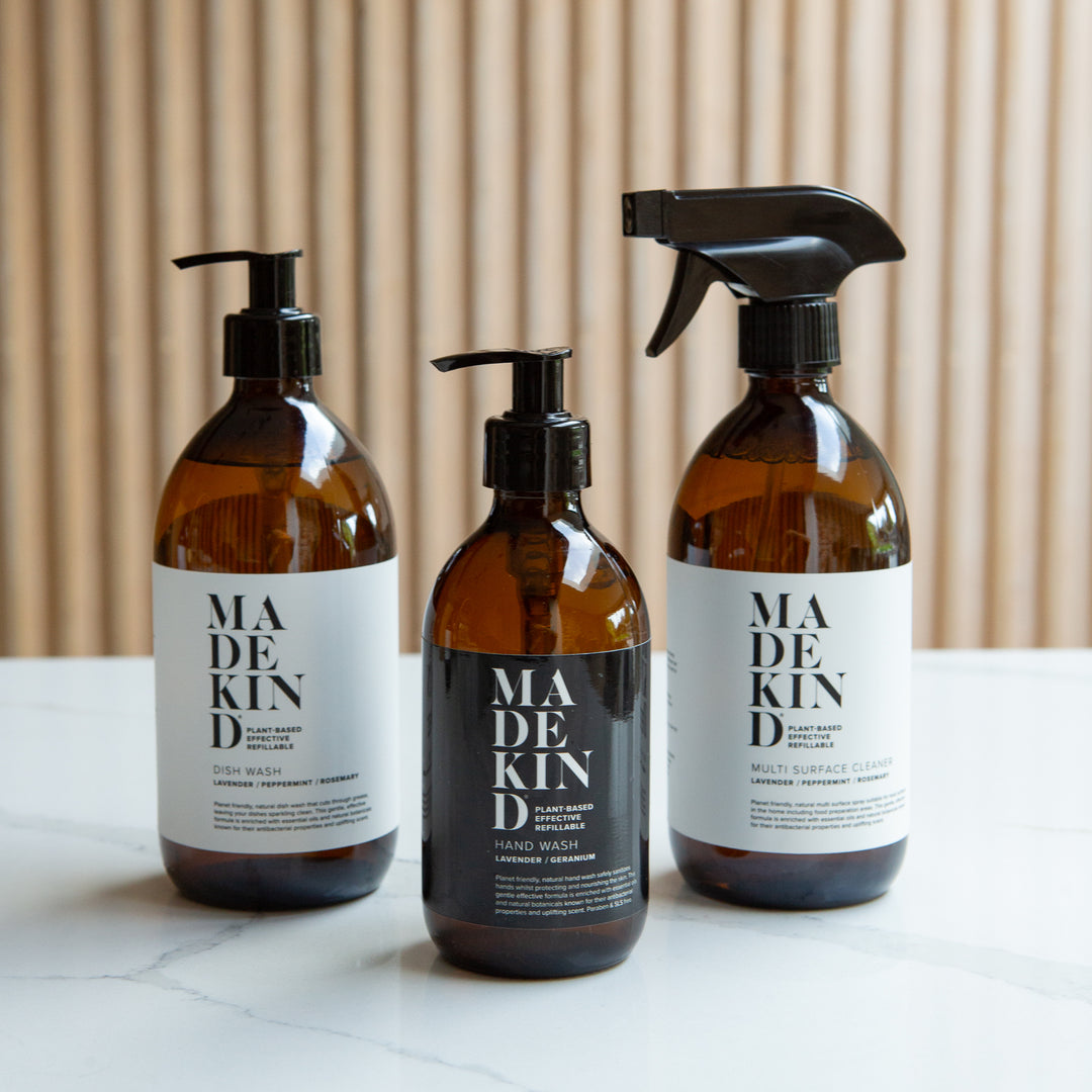 Photo of MadeKind natural multi surface cleaner, dish wash and hand wash with a blured out wooden backdrop