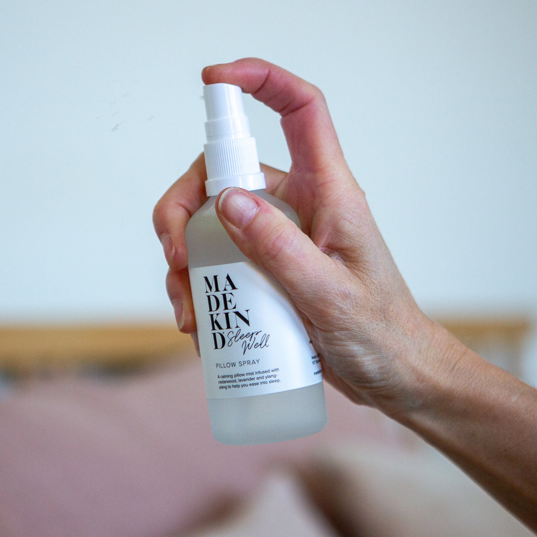 Photo of a hand holding a pillow spray