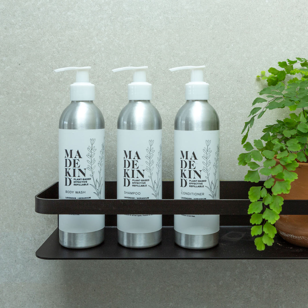 Photo of MadeKind Body Wash, Shampoo and Conditioner in a bathroom shower holder.