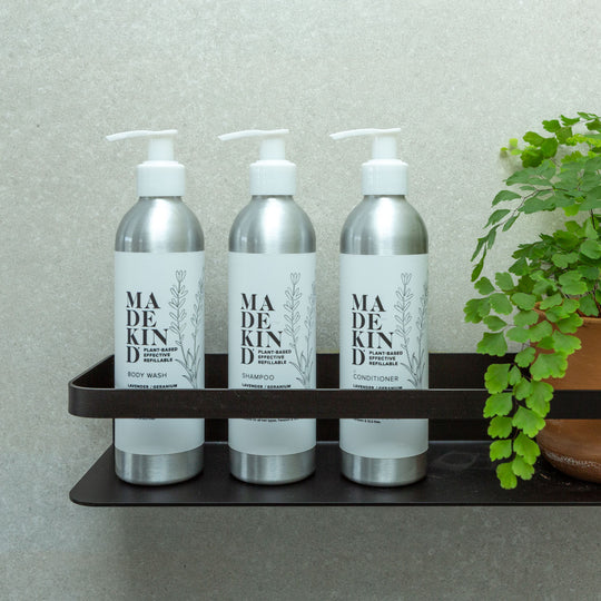 Photo of MadeKind Body Wash, Shampoo and Conditioner in a bathroom shower holder.