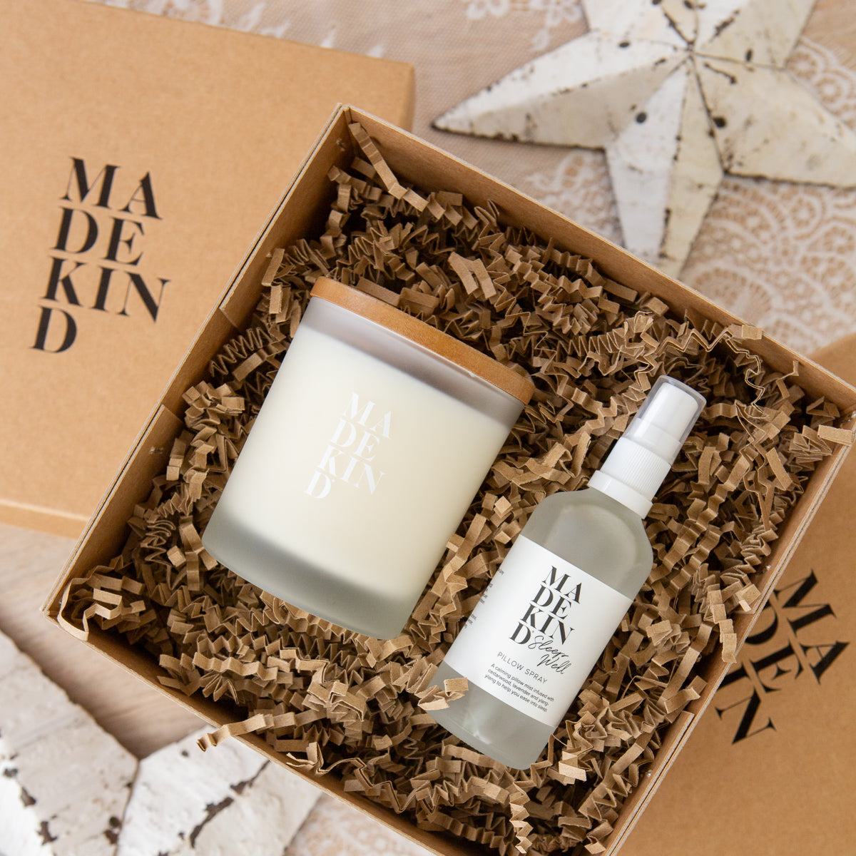 Photo of a gift box containing MadeKind Sleep Well Pillow Spray and Sleep Well Candle.