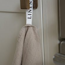 Load image into Gallery viewer, Photo of a tea towel hanging from a hook
