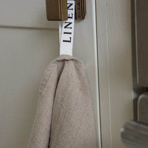 Photo of a tea towel hanging from a hook