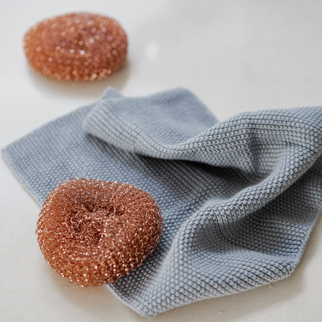 Photo of Redecker copper scourers on a grey madekind cloth