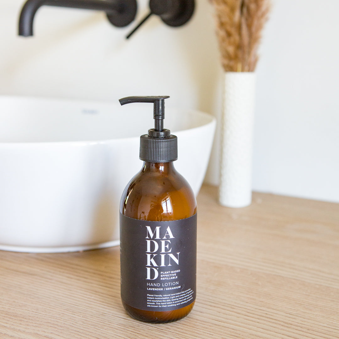 Natural hand lotion in amber glass bottle with lavender and geranium essential oils.